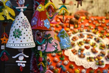 Wall Mural - Florence, ITALY - DECEMBER 2018: small decorated bells hanging from the roof at the Christmas market in front of the 'Basilica of Santa Croce'. Christmas