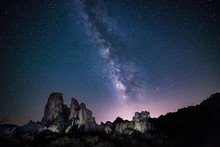 Beautiful Shot Of Silhouettes Of Rocks Under The Purple Sky Full Of Stars - Perfect Wallpaper