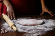 female hands with dough make homemade pasta
