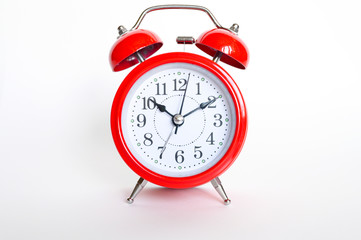 red round analog alarm clock on white background. time 10:10