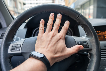 Canvas Print - Drivers hand on a steering wheel of a car.