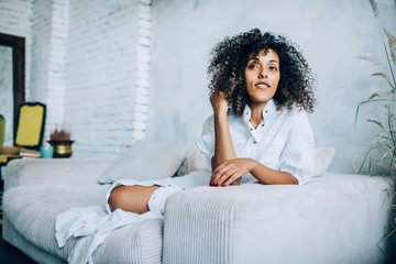 Wall Mural - Young beautiful woman on couch