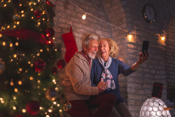 Senior couple taking a selfie on Christmas Eve