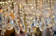 Crystals Of A Crystal Chandelier With Glow And Refraction Of Light. Multi-colored Glare On Transparent Crystals. A Curtain Of Crystal Droplets.