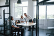 © standret - Talking about project. Young business people in formal clothes working in the office