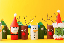 Merry Christmas Toy Collection Santa Claus, Snowman, Tree, Reindeer On Yellow For Winter Holiday Concept Background. Paper Crafts, DIY. Creative Idea From Toilet Roll