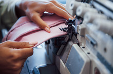 Detailed View Of Dressmaker Woman Sews Clothes On Sewing Machine In Factory