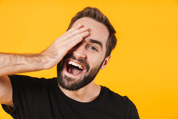 Poster - Image of attractive man in t-shirt laughing and touching his face