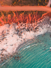 An Aerial View Of Gantheaume Point In Broome, Western Australia. Showing The Contrast Between The Red Cliffs, White Sandy Beach And The Turquoise Indian Ocean During Golden Hour.