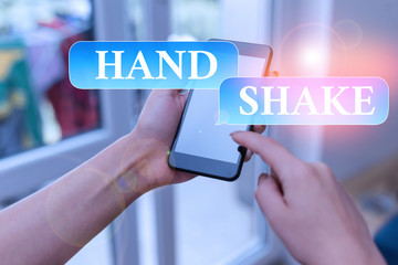 Poster - Text sign showing Hand Shake. Business photo text an act showing that you have made an agreement or greeting woman using smartphone office supplies technological devices inside home