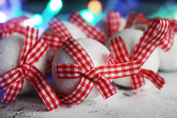 Set of white Christmas balls with red bows so close