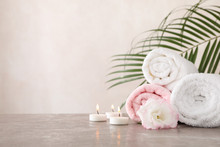 Towels, Candles And Flower On Grey Background, Space For Text