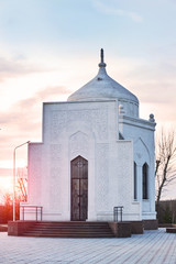 Wall Mural - Mausoleum of Ibray Altynsarin in Kostanay, Kazakhstan, in autumn 2019.Against a bright sunset.