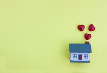 Beautiful Little House, Red Hearts Fly Out Of The Pipe On A Yellow Background. The Concept Of Happiness In Your Home, Buying, Selling, Renting A Property, Mortgage