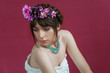 © Pere Chuliá - Young woman dancing with white dress and flowers in her hair. Red background.