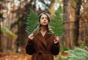 Sticker - Style woman with fern branch in a autumn time forest