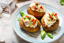 Baked Stuffed Potatoes With Bacon, Tomato, Cheese On Concrete Background.