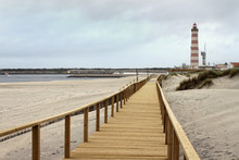 Boardwalk In Praia Barra With Lighthouse