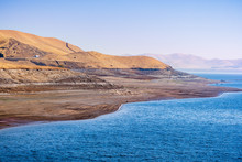 The Shoreline Of San Luis Reservoir, An Artificial Lake Storing Water For Agricultural Purposes In Central California; Visible Low Water Level Towards The End Of Fall; Merced County, California;