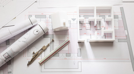 Construction concept. Residential building drawings and architectural model,