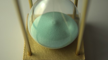 Wall Mural - Extreme close up view of sand flowing through an hour glass. Super closeup of hourglass clock middle.  Classic sandglass timer countdown.