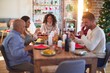 © Krakenimages.com - Beautiful family smiling happy and confident. Eating roasted turkey and toasting with cup of wine celebrating Christmas at home