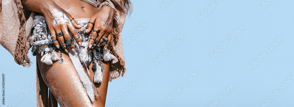 Obraz na płótnie close up of young fashionable stylish woman with tanned skin wearing stylish boho accessories on blue sky background w salonie