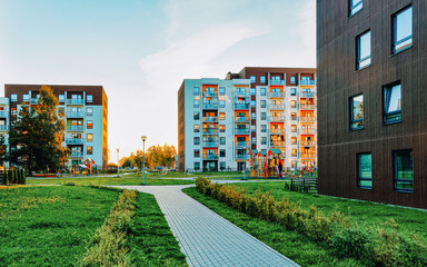 Canvas Print - Modern residential apartment and flat building exterior with outdoor facilities. New luxury house and home complex and green yard. City Real estate property and condo architecture. Empty background