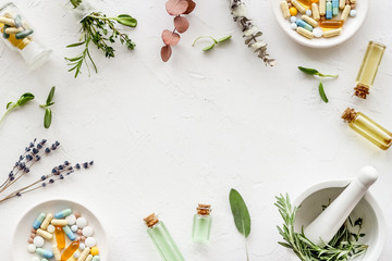 Apothecary of natural wellness and self-care. Herbs and medicine on white background top view frame copy space