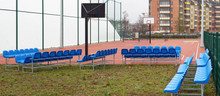 Blue Plastic Benches On Metal Frames Near The New Modern  Stadium