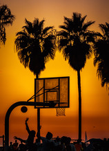 Sunset At Santa Monica Pier: Peoples Playing Basketball With Palm At Background