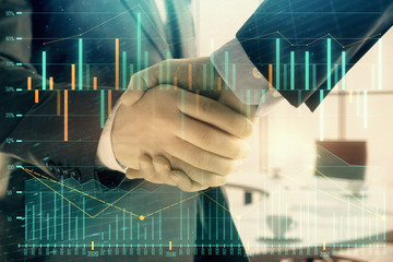 Multi exposure of financial graph on office background with two businessmen handshake. Concept of success in business