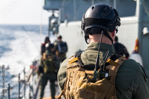 Fotografía Military soldiers boarding group control and search for refugees on ship deck during operation on sea