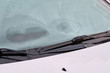 Closeup of the wipers under a frozen windshield of a white car. Seen on a cold November morning in Franconia / Bavaria, Germany.