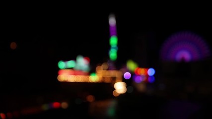 Wall Mural - colorful blurry lights at night at fun fair carnival