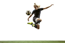 Young Female Soccer Or Football Player With Long Hair In Sportwear And Boots Kicking Ball For The Goal In Jump On White Background. Concept Of Healthy Lifestyle, Professional Sport, Motion, Movement.