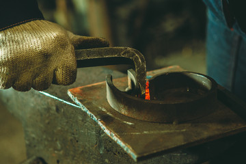 Incandescent element in the smithy on the iron anvil