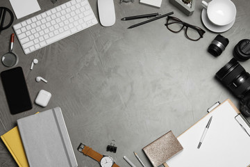 Flat lay composition with computer accessories and different office items on grey stone background, space for text. Designer's workplace