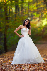 Bride in white dress in the forest