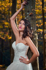 Bride in white dress in the forest