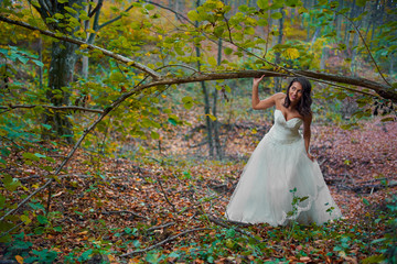  Bride in white dress in the forest