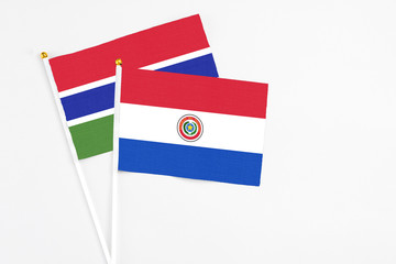 Paraguay and Georgia stick flags on white background. High quality fabric, miniature national flag. Peaceful global concept.White floor for copy space.