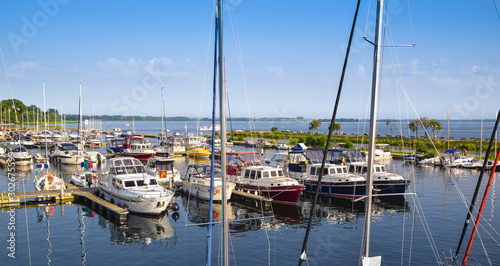 Boats moored at the marina in Gizycko at Lake Niegocin, Gizycko, Masuria, Pol...