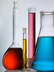 Wall Mural - different laboratory glassware with color liquid and with reflection