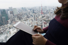 Business Woman Using Tablet Over View Of Tokyo Tower.