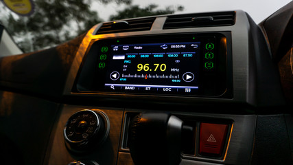 The close up view of the smart multimedia touchscreen radio panel in the car.