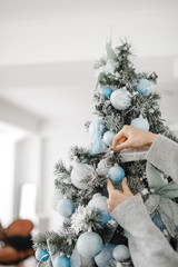 woman decorating beautiful Christmas tree