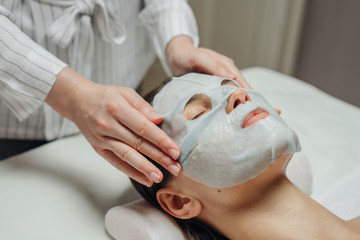 Cosmeotologist Putting a Facial Mask