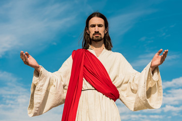 Poster - bearded jesus with outstretched hands against blue sky