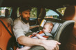 © EVERST - Father and baby in car child sitting in safety seat happy family lifestyle road trip vacations rental auto rear-facing transportation